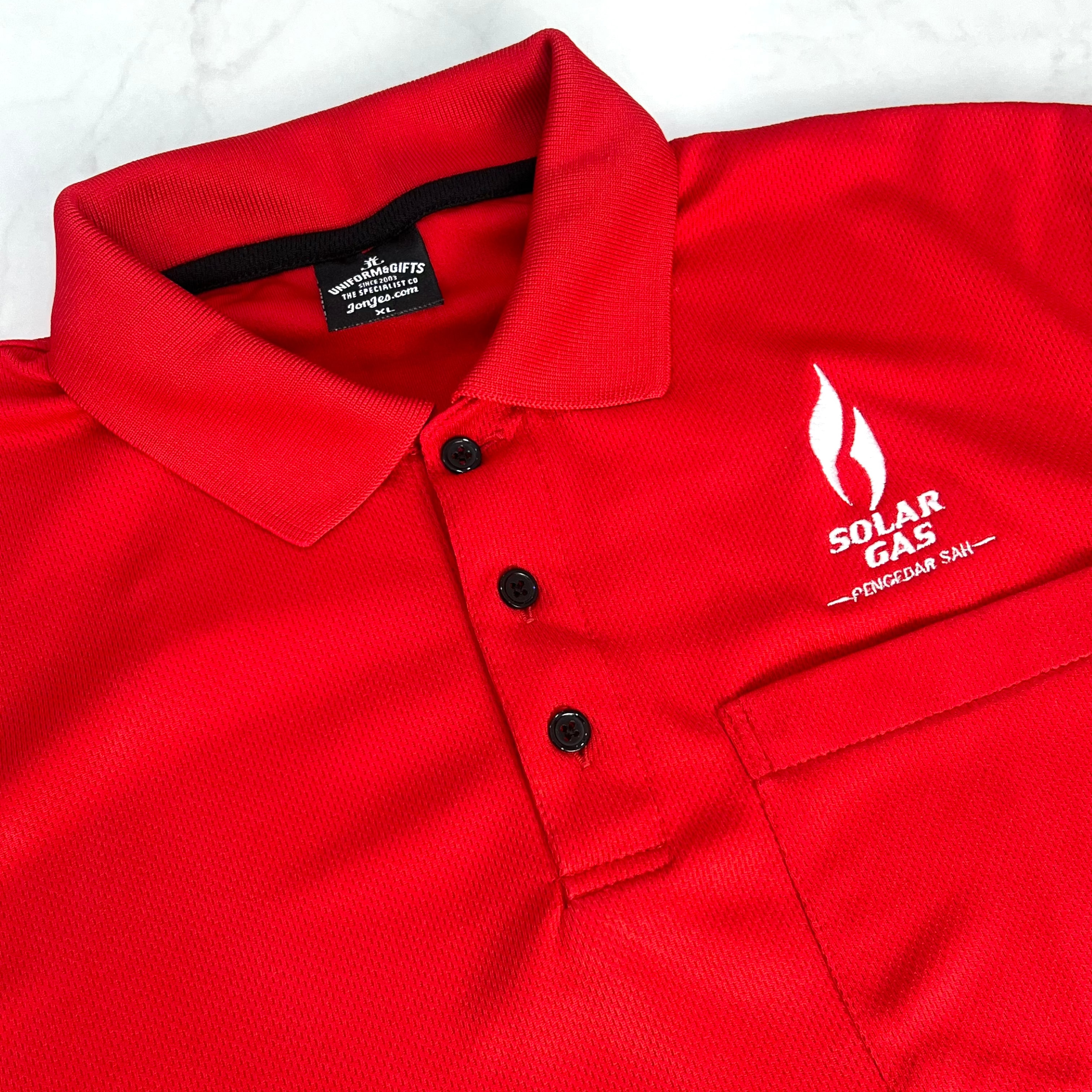 Red polo shirt with Solar Gas logo on a white background